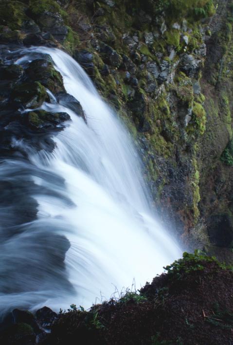 waterfall running down the edge of a cliff