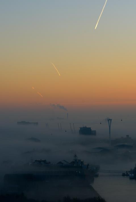 Smog spreads over an industrial plant. 