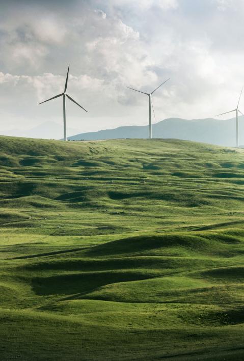 wind turbines on green hills. 