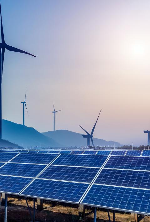 mountains with wind turbines and solar panels