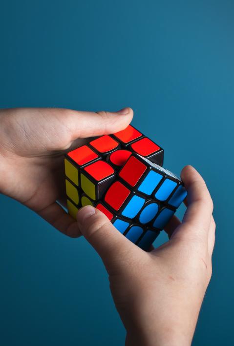 One hand twists a Rubik's cube. 