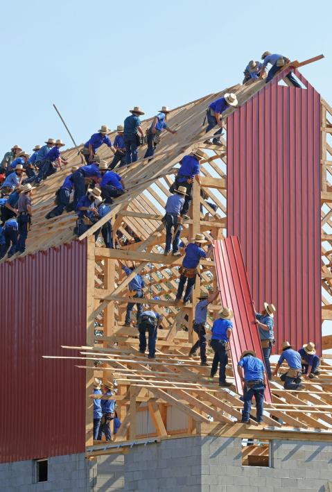 Workers build a big house. 