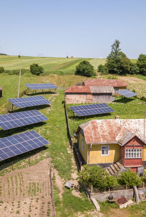 house, barns and solar panels in a wide landscape