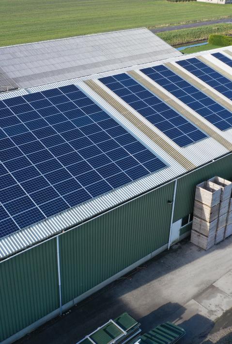 Bird's eye view of a hall with photovoltaic panels on the roof