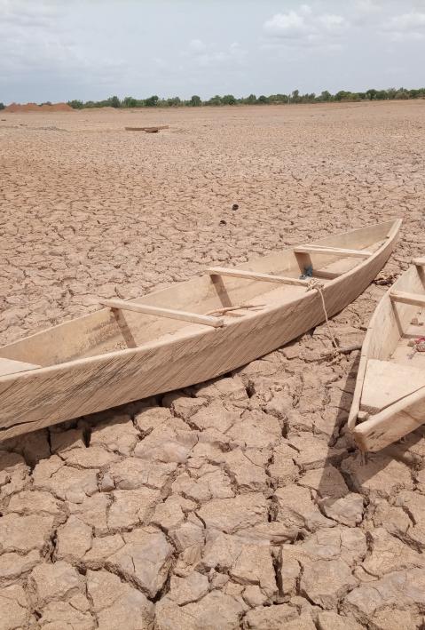 Two wooden boats lying in a dried riverbed