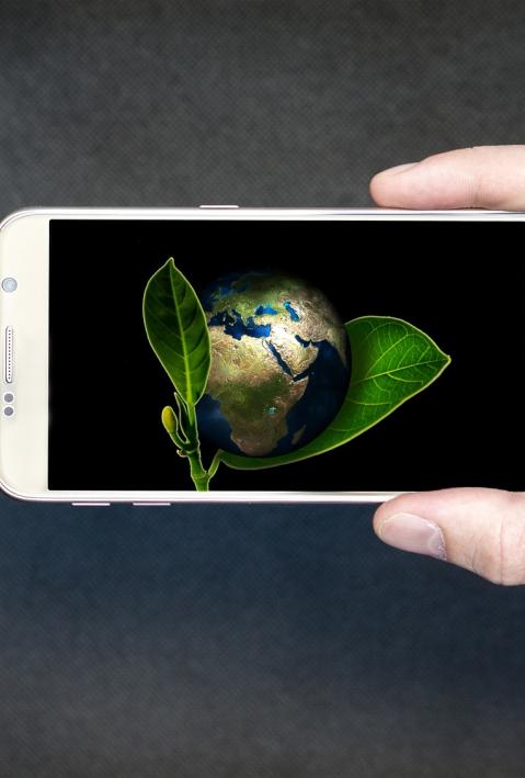 hand holding smartphone with earth on display