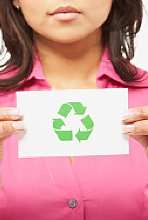 Asian woman holding recycling symbol