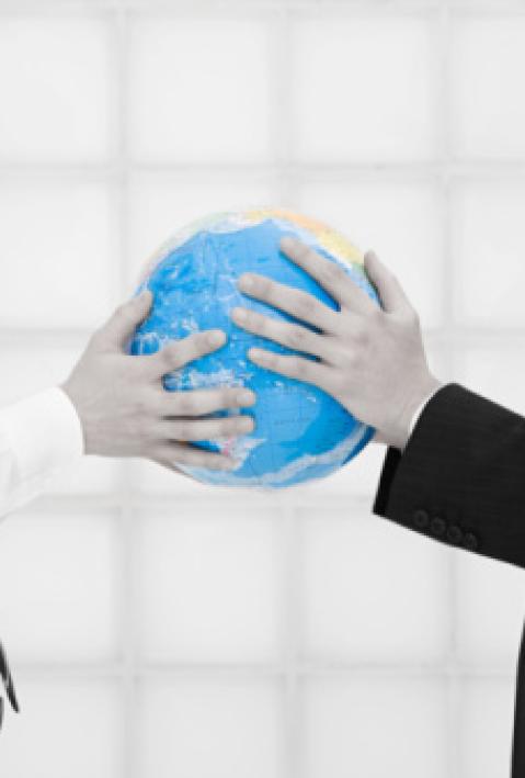 Office workers holding globe