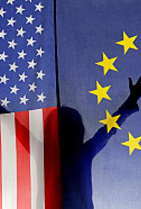 Silhouette of girl (6-7) waving hands behind US and European Union flags