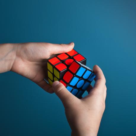 One hand twists a Rubik's cube. 