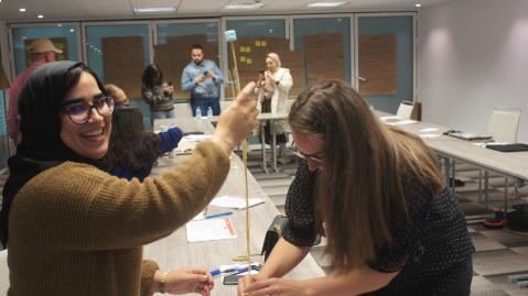 Two participants building a tower out of thin material during a SEED Starter workshop in Casablanca, Morocco
