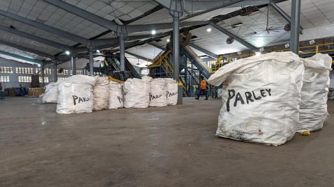 big garbage bags from Parley of the Ocean filled with trash in a big storage unit