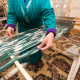 Hands of a weaver working on manual weaving loom & making Ikat