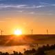 green landscape with wind turbines at dawn 