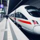 Front of a stationary ICE train with passers-by on the platform