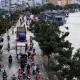 HO CHI MINH CITY, VIET NAM- OCT 18, 2016: Awful flooded street at Asian city, crowd of people ride motorcycle wade in water from tide on road, climate change make sea level rise, Vietnam